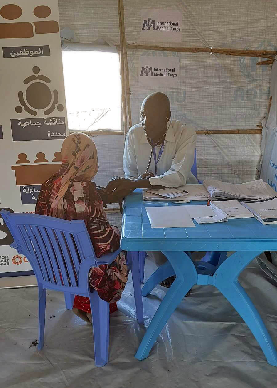 An International Medical Corps clinical officer provides an outpatient consultation for a displaced woman at a mobile clinic in Renk, South Sudan.