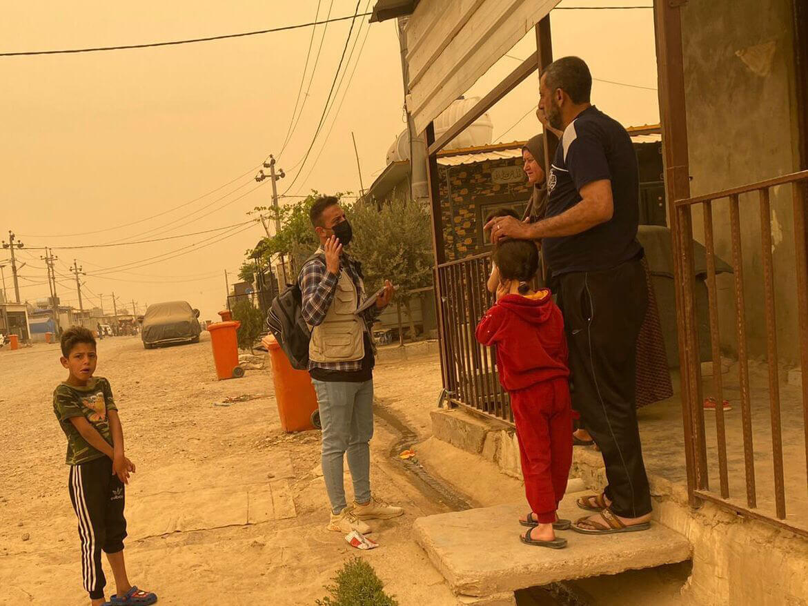 When visiting members of their community to check on their well-being, International Medical Corps staff members wear facemasks to protect themselves from airborne sand and other particulates, and keep a close eye on weather reports.