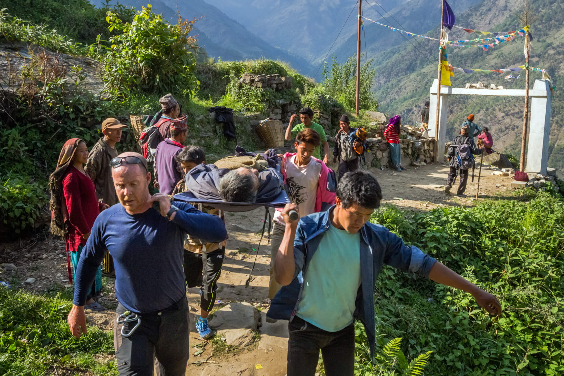 Dr. Michael Karch and a team of villagers work together to bring an injured man to safety during a rescue mission in Nepal in 2015.